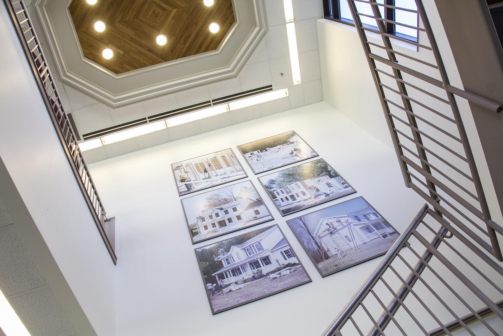 Six portraits of a house hung up on a wall